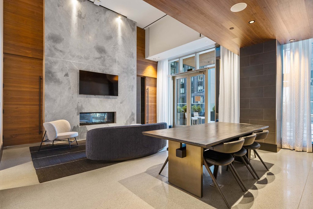 a dining room with a table and chairs in front of a fireplace at The Paxton, New york